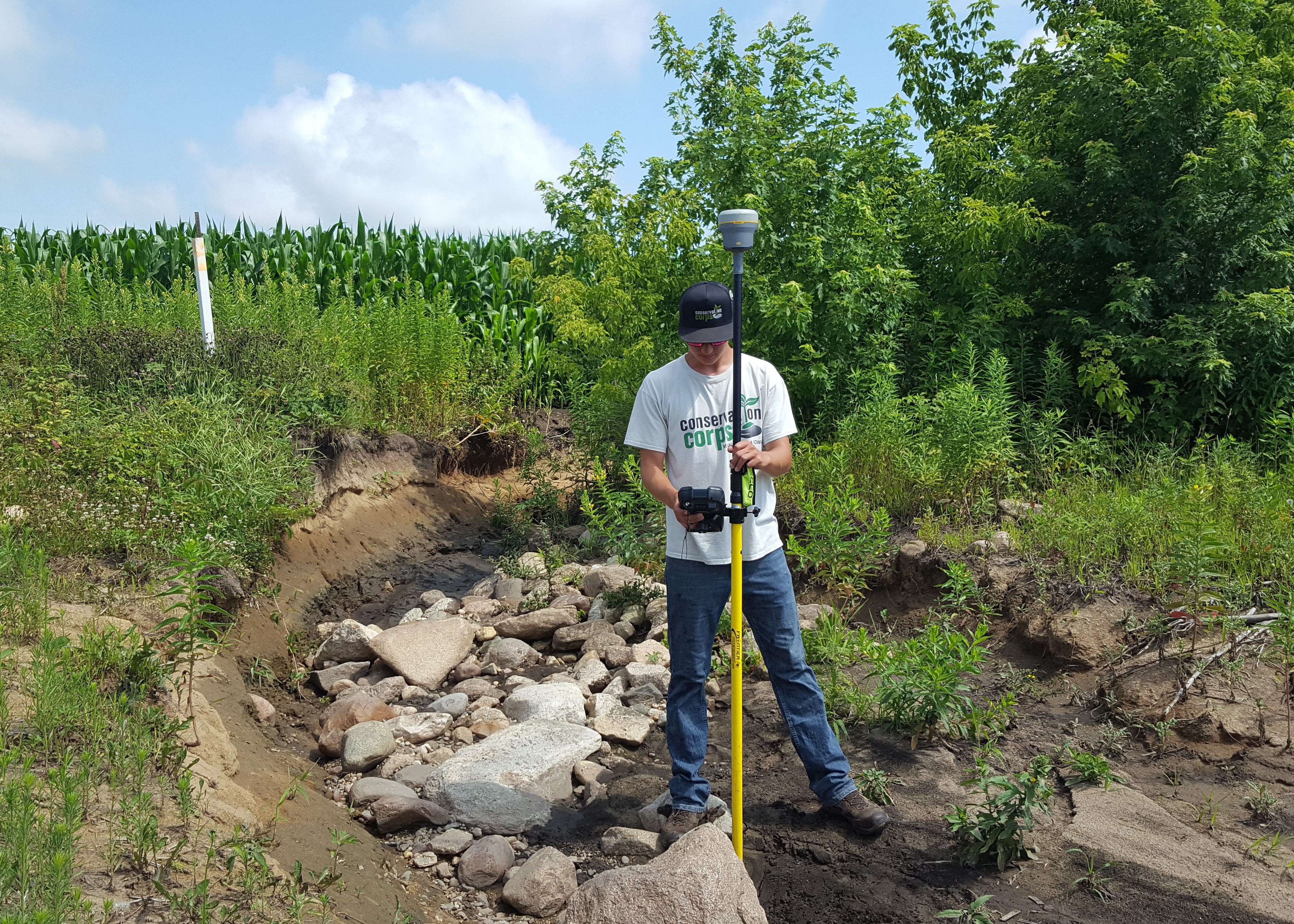 A Conservation Corps apprentice surveys a highly erosive area in 2017 in Mower County. This issue was later addressed through the EQIP program.